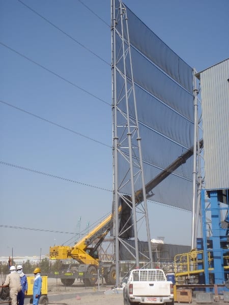 Wind fence in Oman - Installing fabric on a dust control wind fencing in Oman 30m x 3200m around a steel pelletizing plant